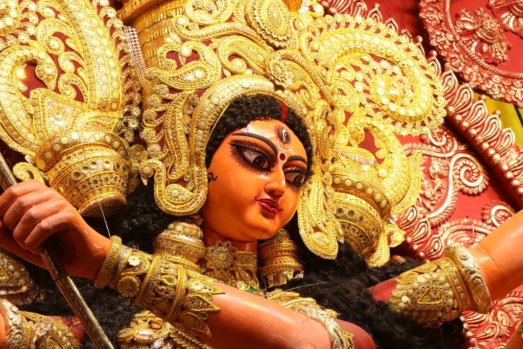 Close-up of a beautifully adorned Durga idol during Hindu festival celebrations, showcasing intricate details.
